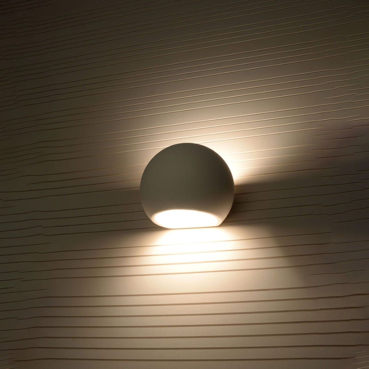 Sollux Lighting modern ceramic wall lamp with round shape illuminating textured wall surface