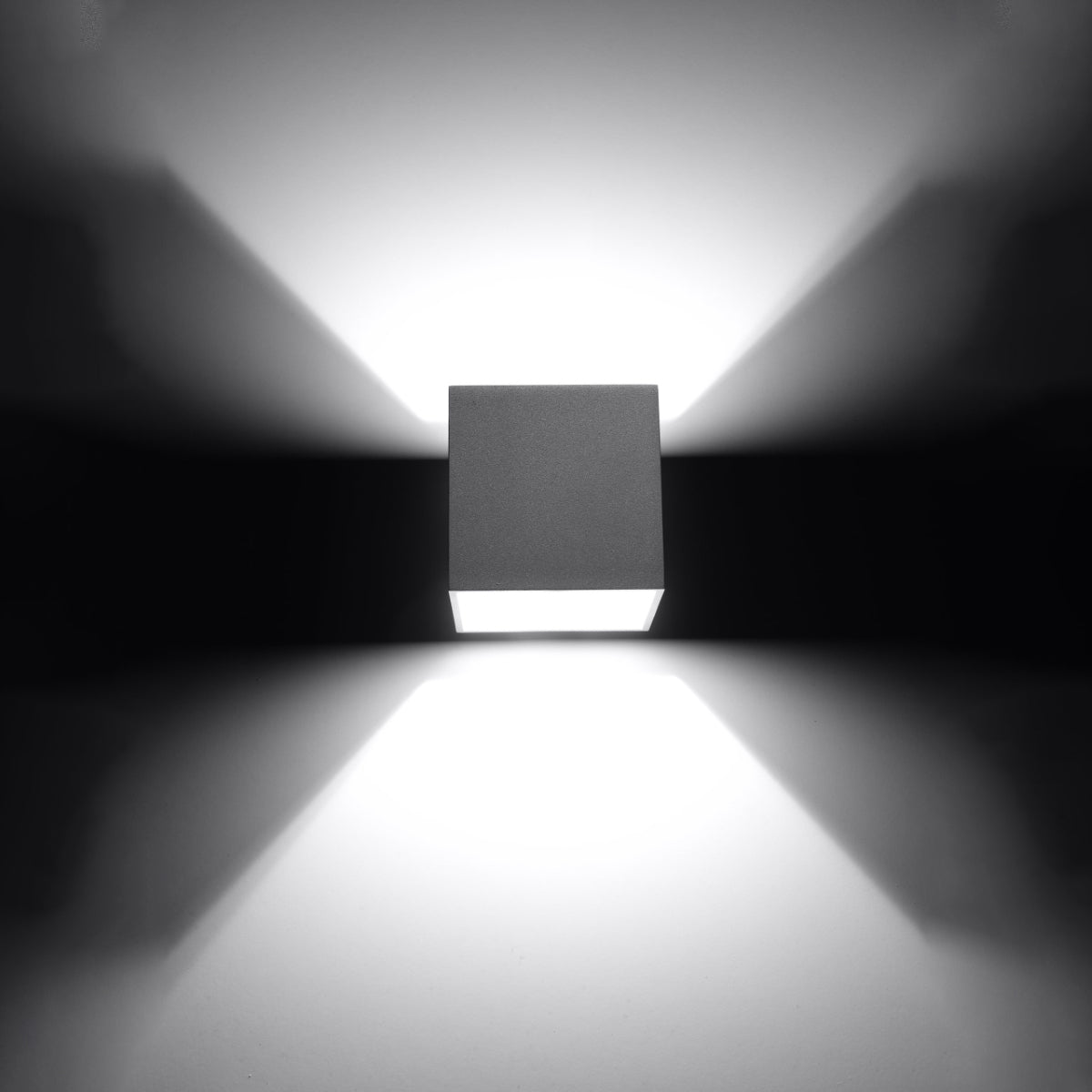 Sollux Lighting modern grey cube wall lamp casting light patterns on a dark wall