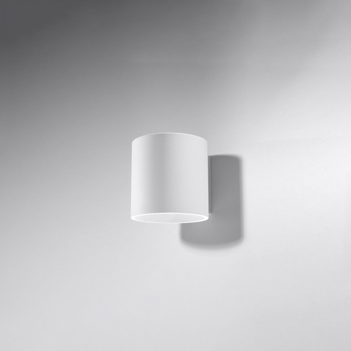 ORBIS 1 wall lamp by Sollux Lighting with a minimalist white cylindrical design mounted on a white wall