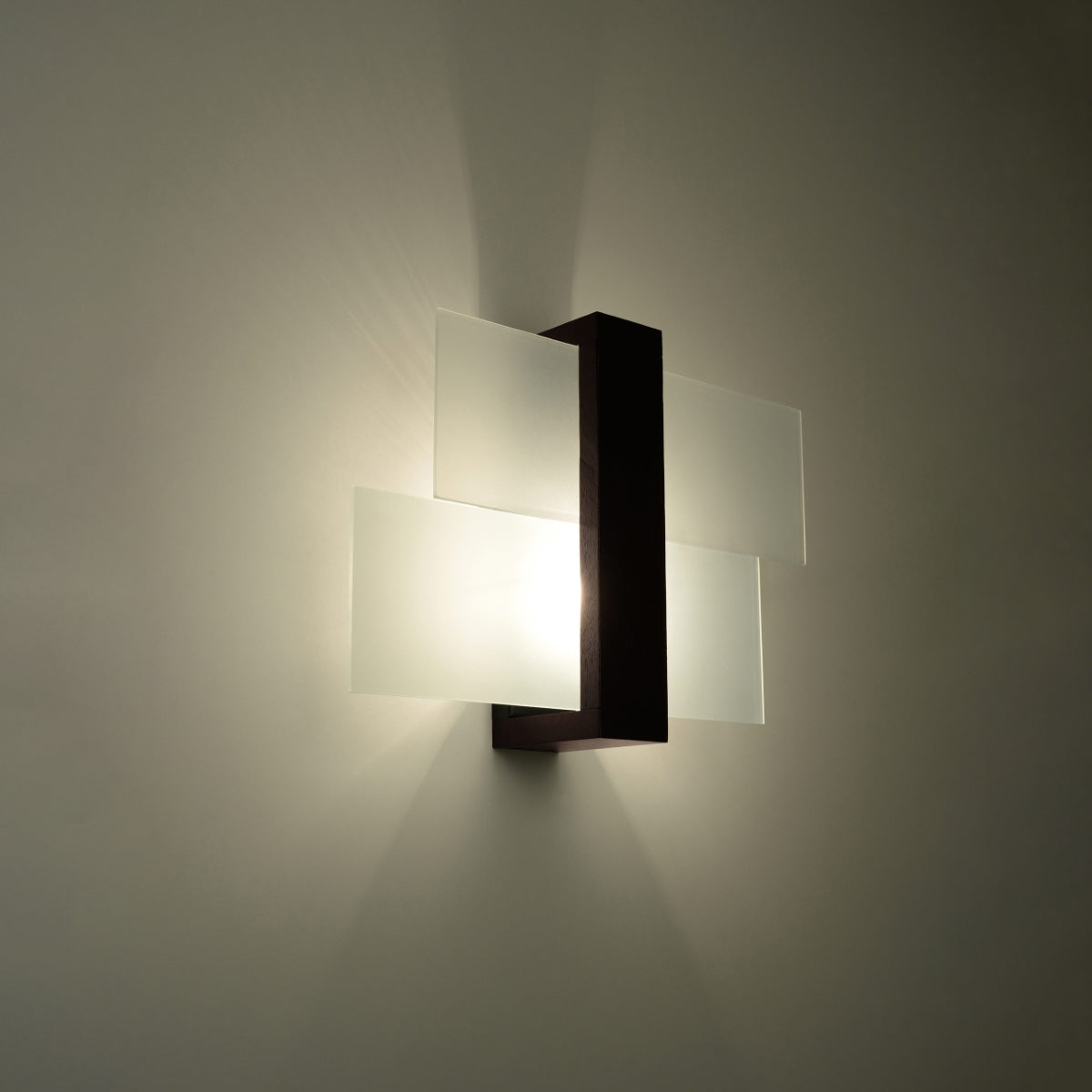 FENIKS 1 wall lamp for living room by Sollux Lighting modern frosted glass sconce with dark metal backplate emitting warm light