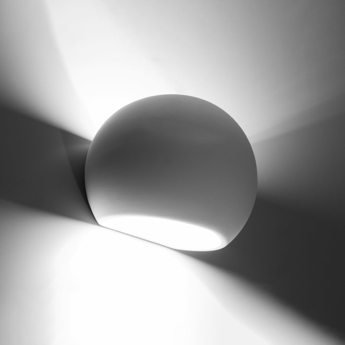 Sollux Lighting modern ceramic wall lamp with smooth rounded design casting ambient light